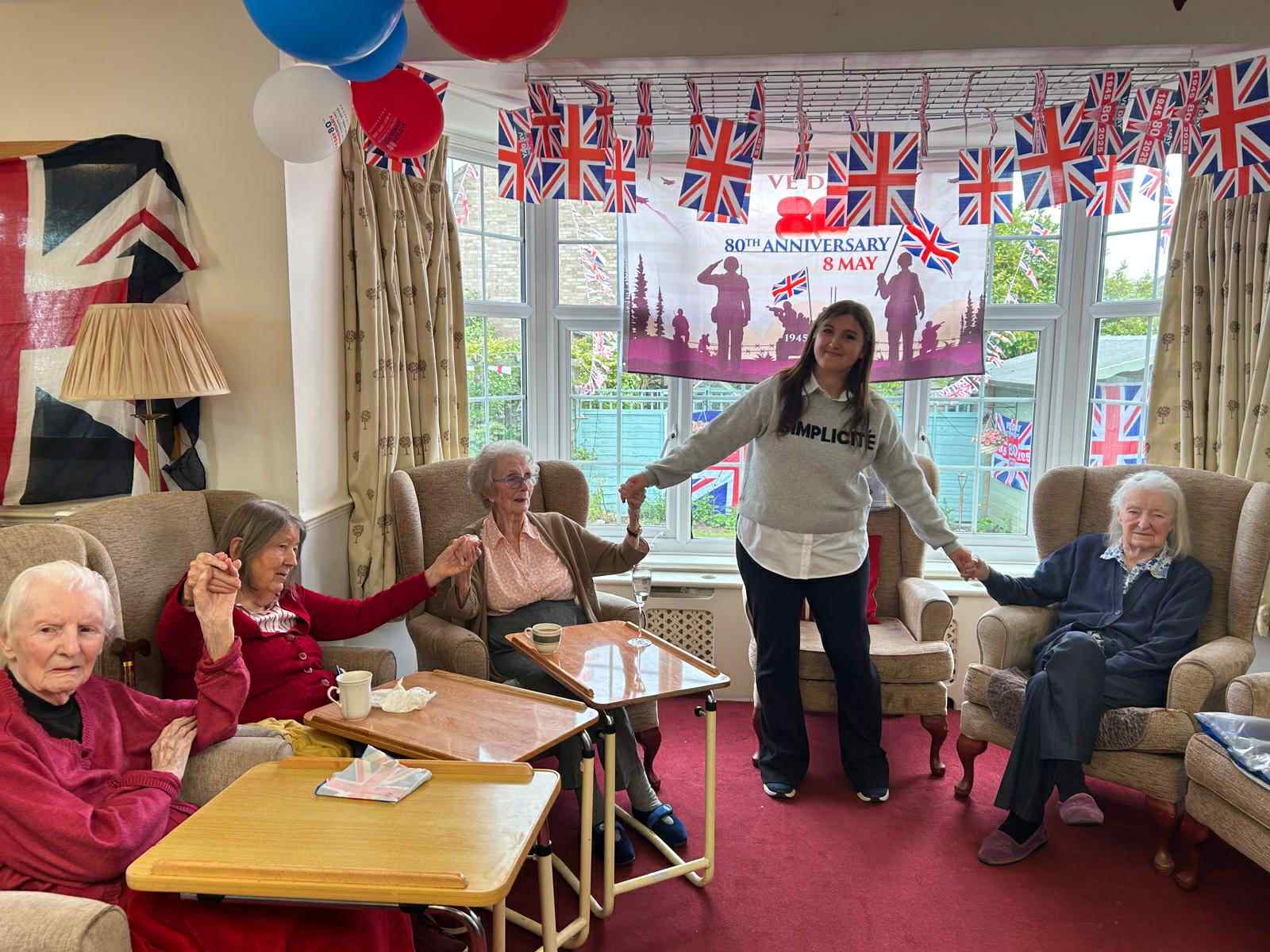 Residents celebrating an anniversary with a staff member