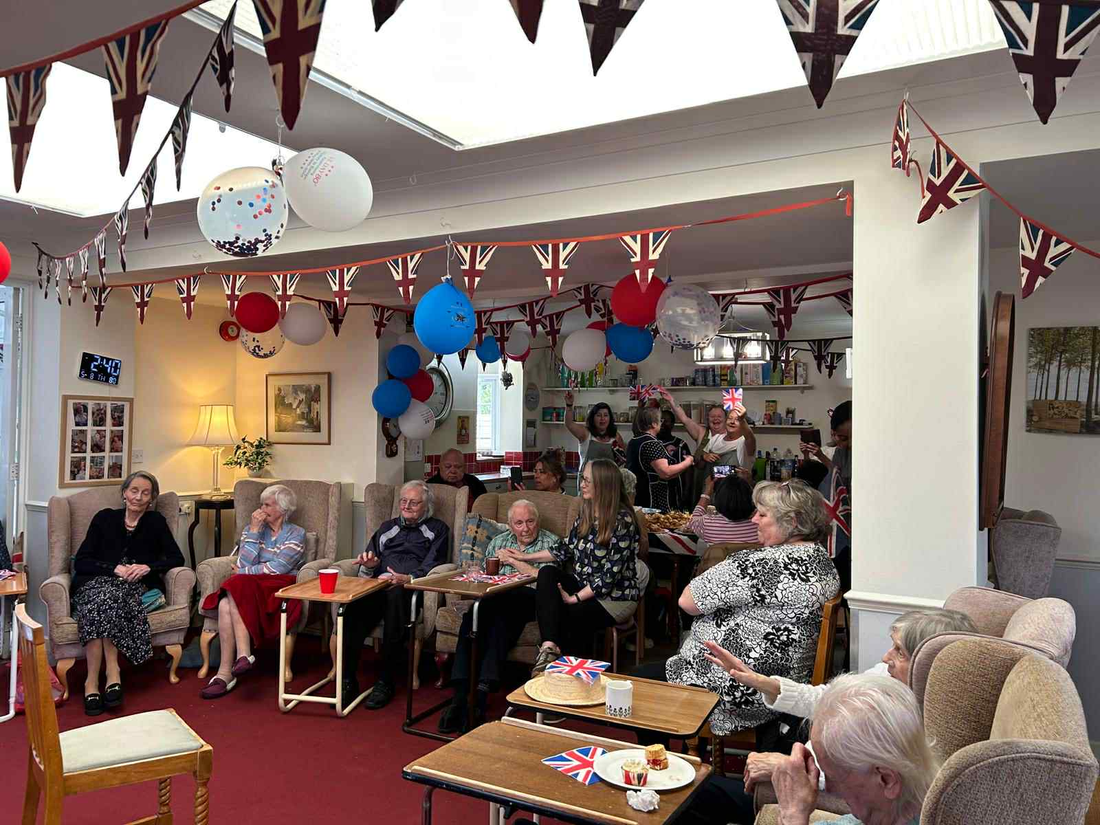 Residents and staff celebrating with decorations and food