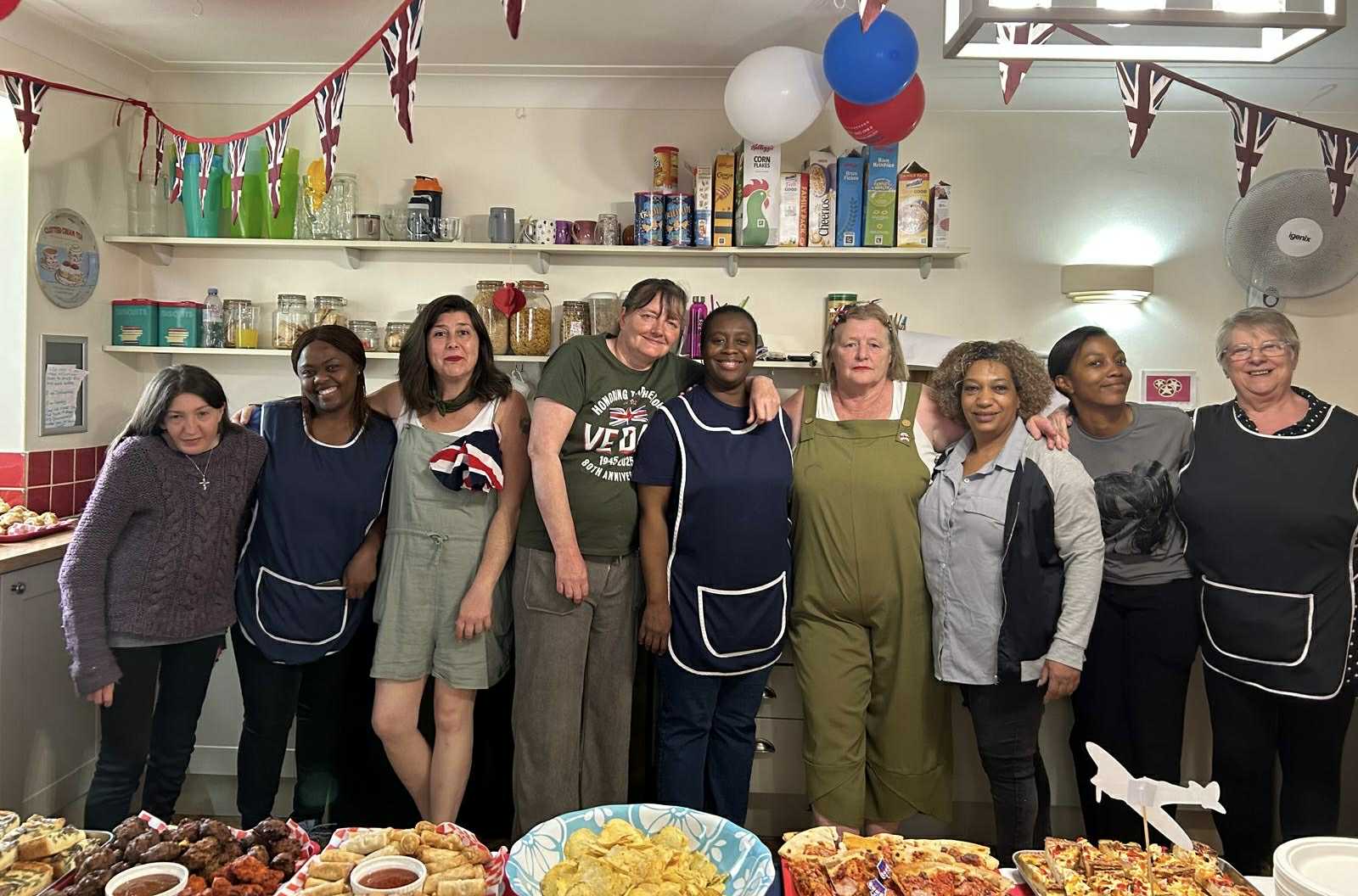 Staff and residents in a lively kitchen setting