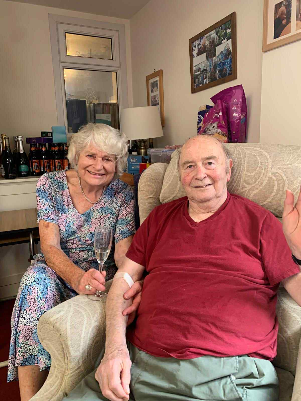 Two residents enjoying time together in a cozy living area