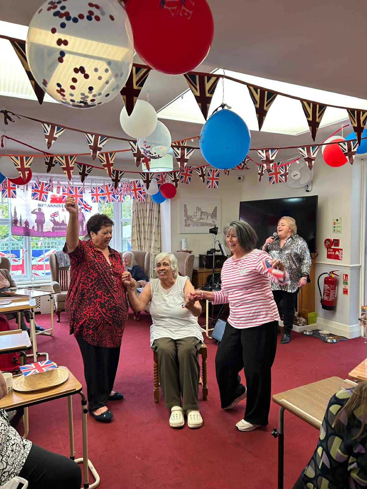 Residents enjoying a celebration in a common area