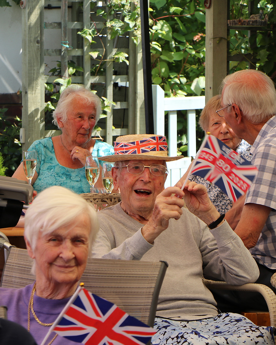 Residents celebrating with flags in an outdoor space
