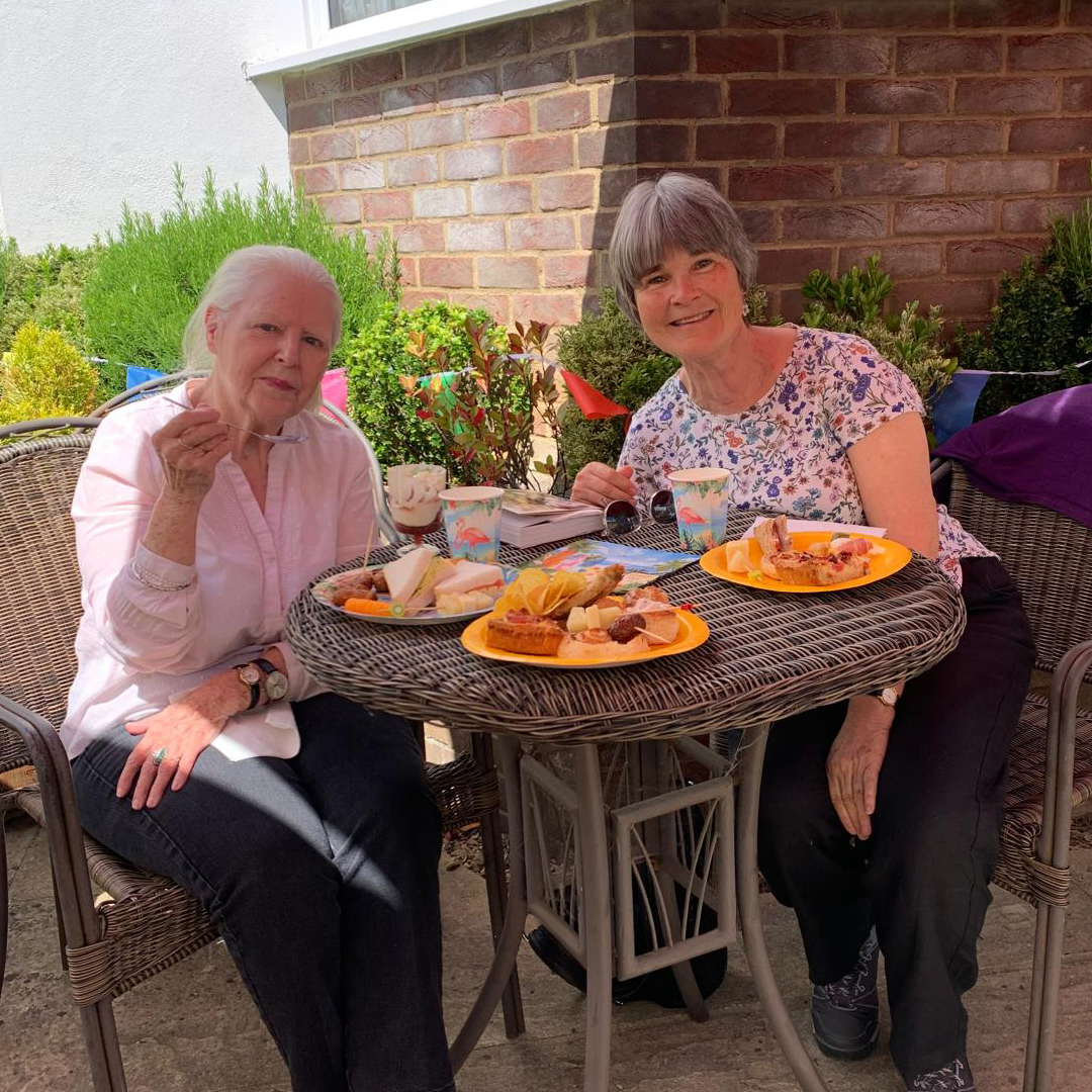 Two residents enjoying lunch outside