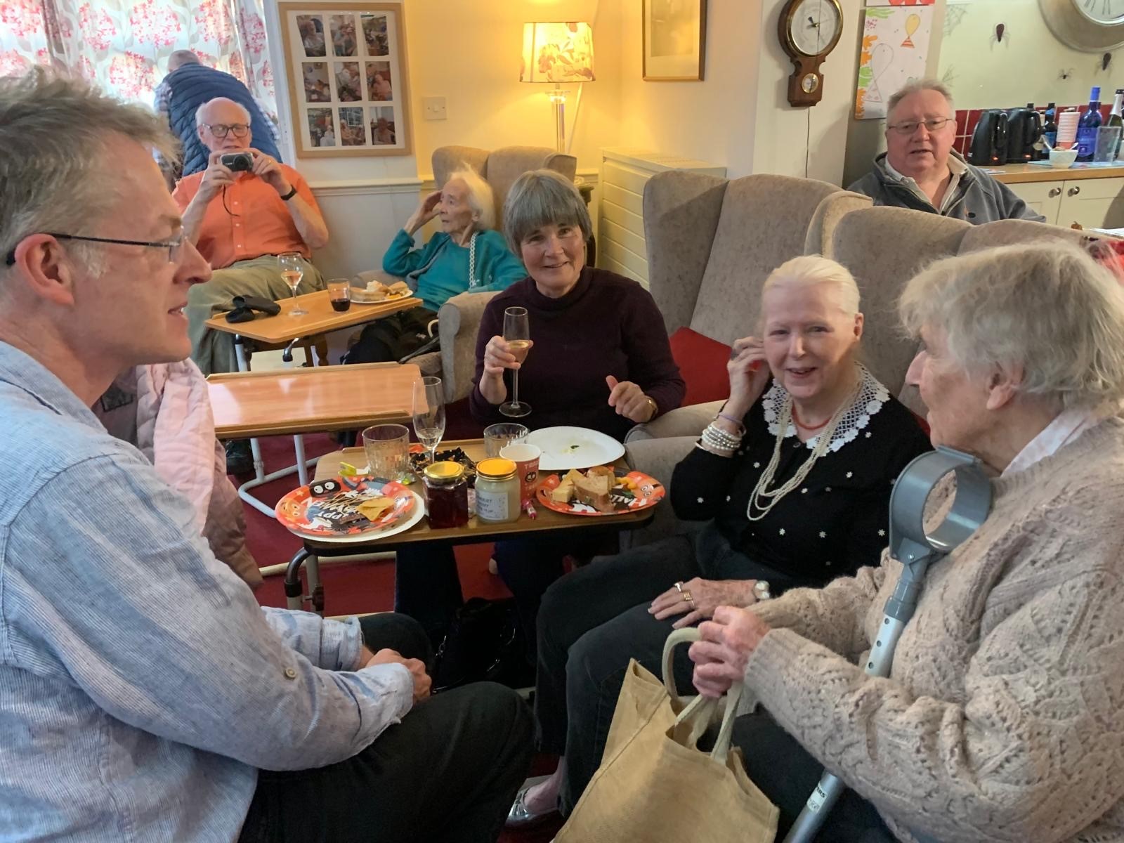 Residents enjoying a festive gathering with food and drinks