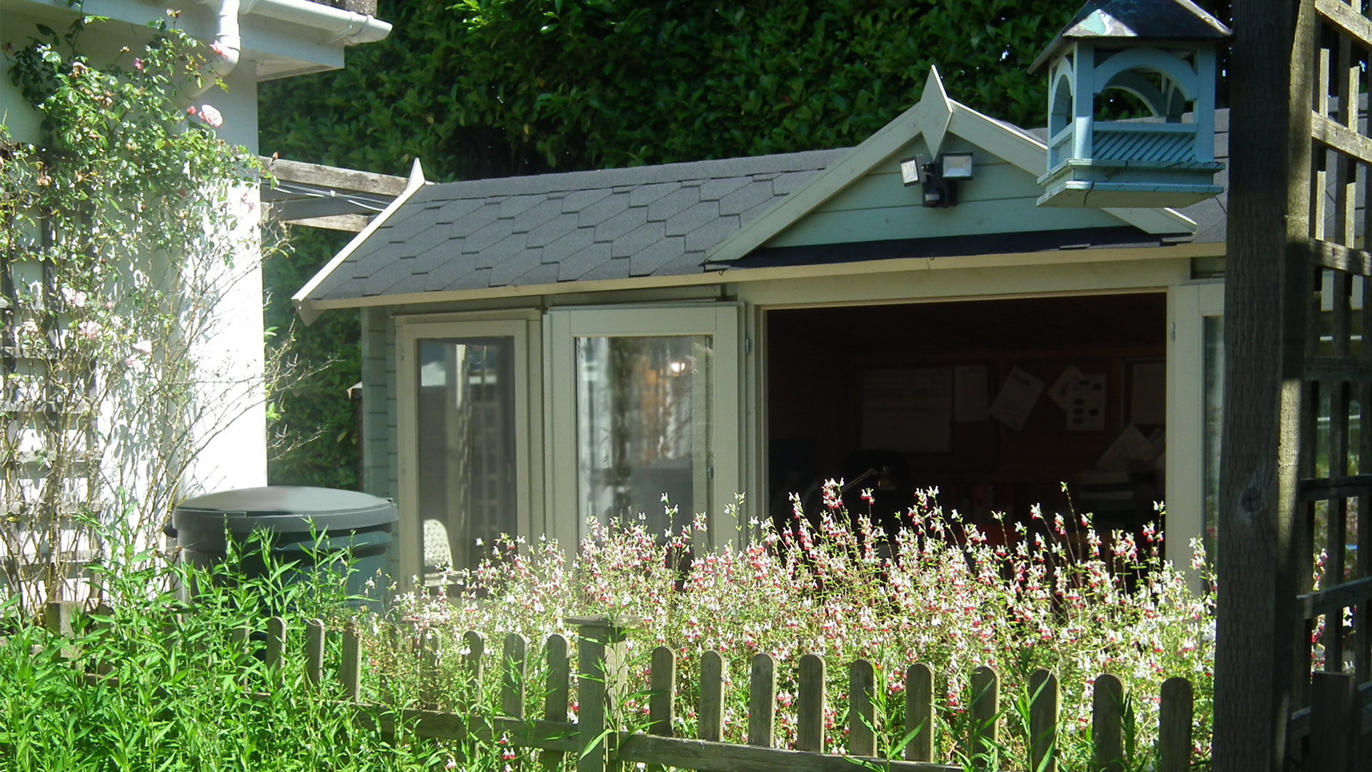 Outdoor garden area with a small building