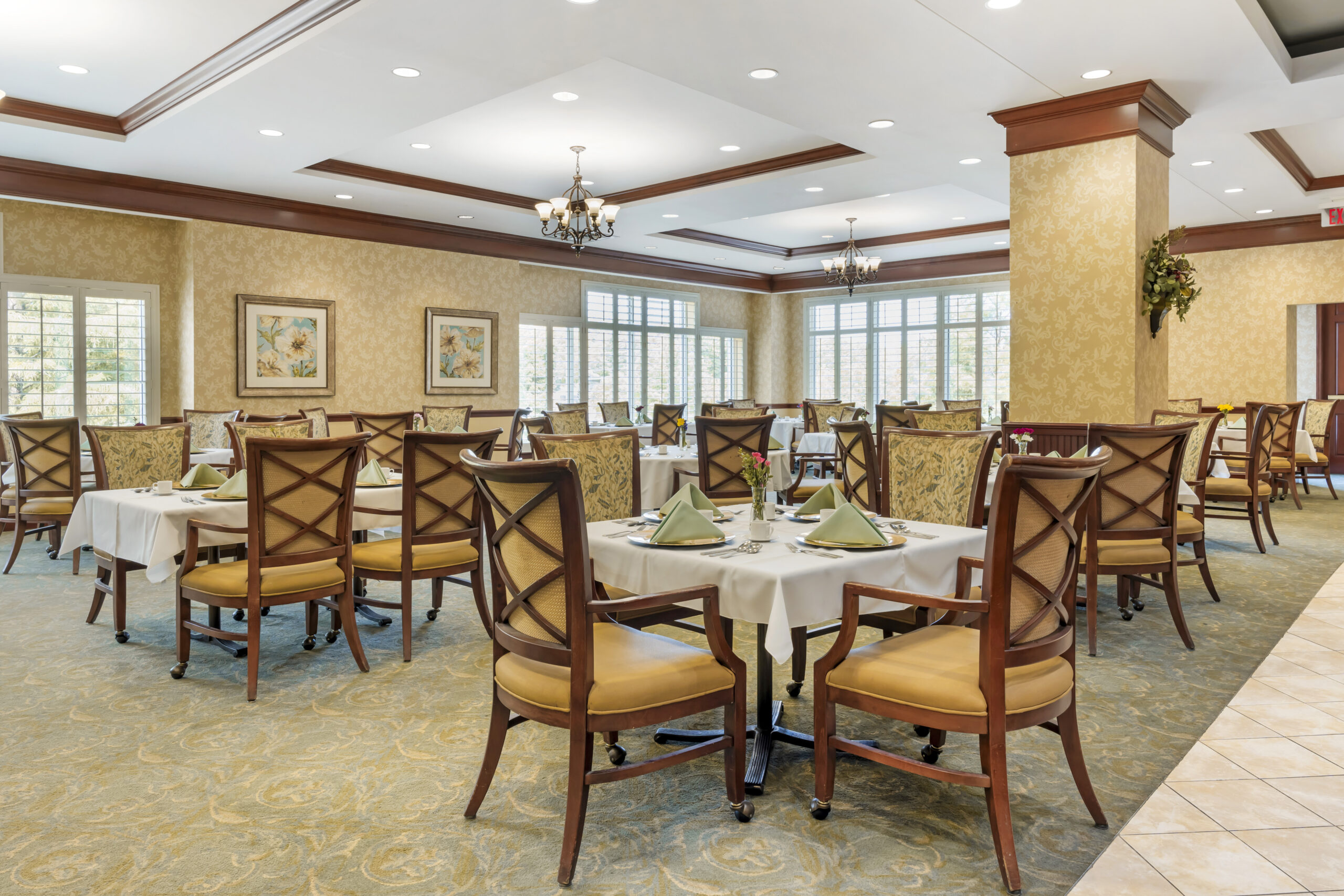 Bright dining room with tables set for meals