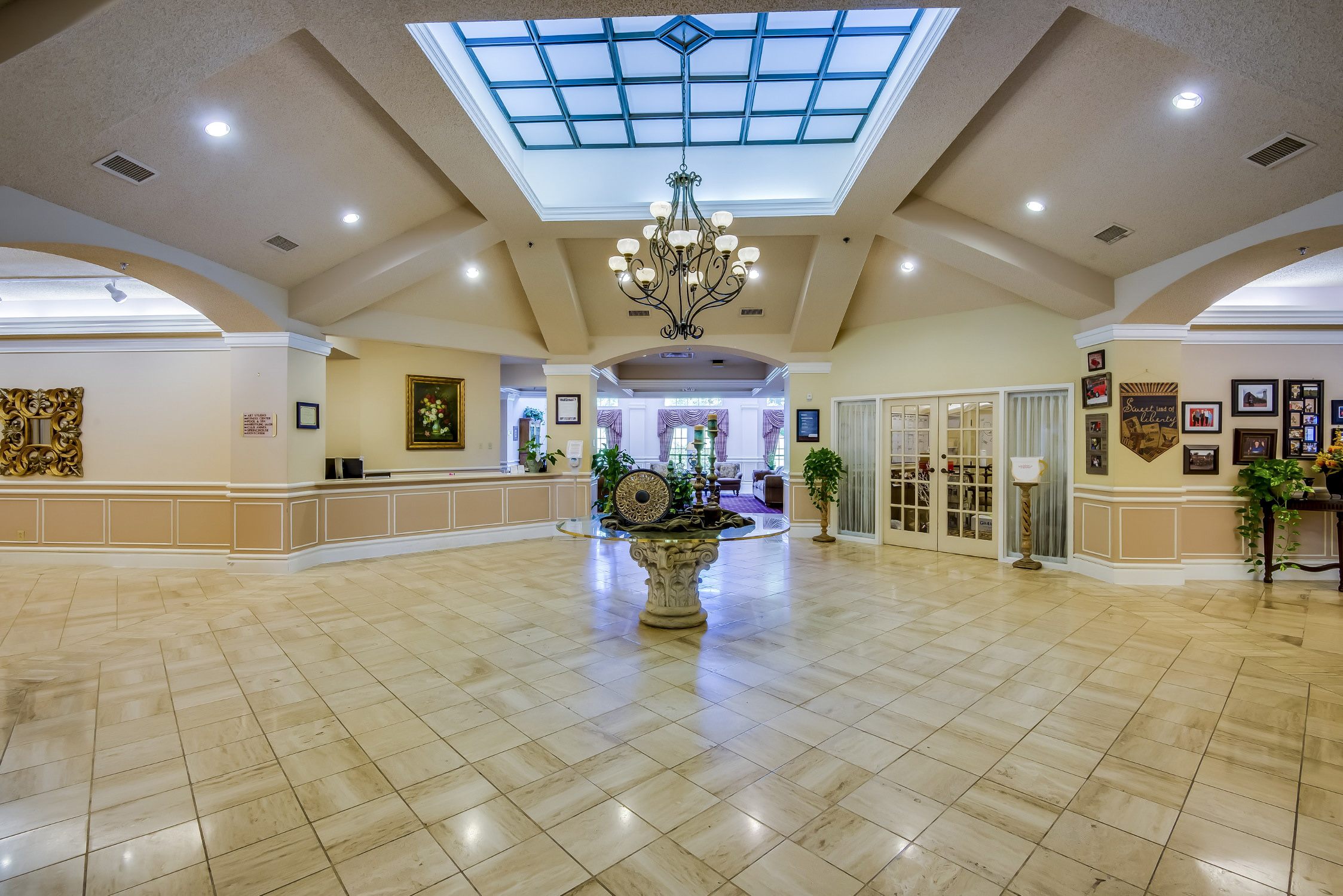 Interior view of a spacious lobby area with chandelier