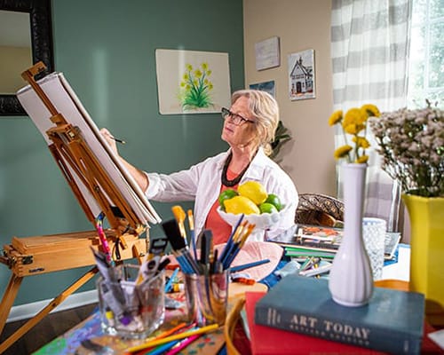 Resident painting in an art activity room