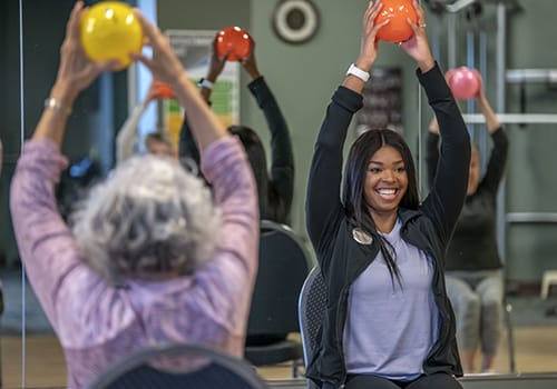 Residents participating in a fitness class with exercise balls
