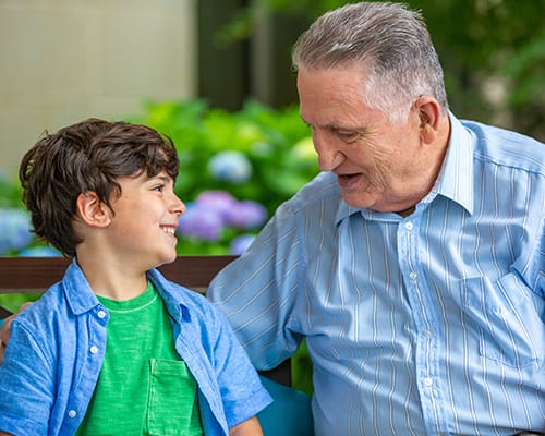 Elderly man enjoying time with a young boy outdoors