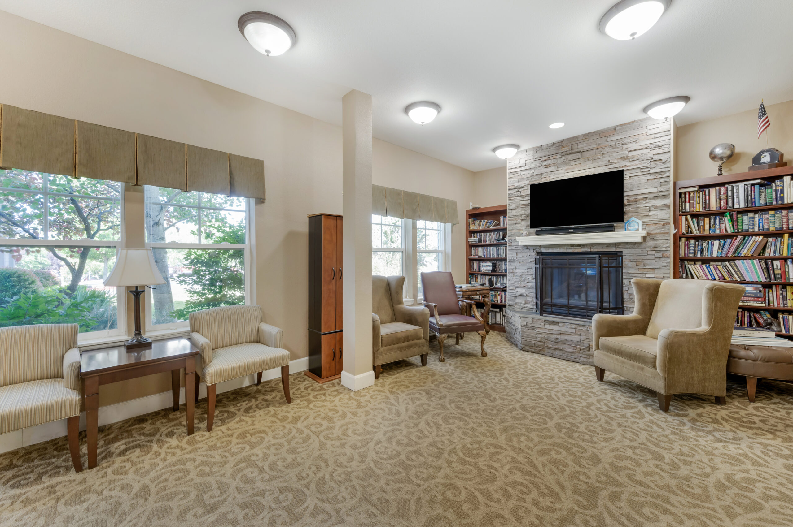 Bright common area with comfortable seating and bookshelves