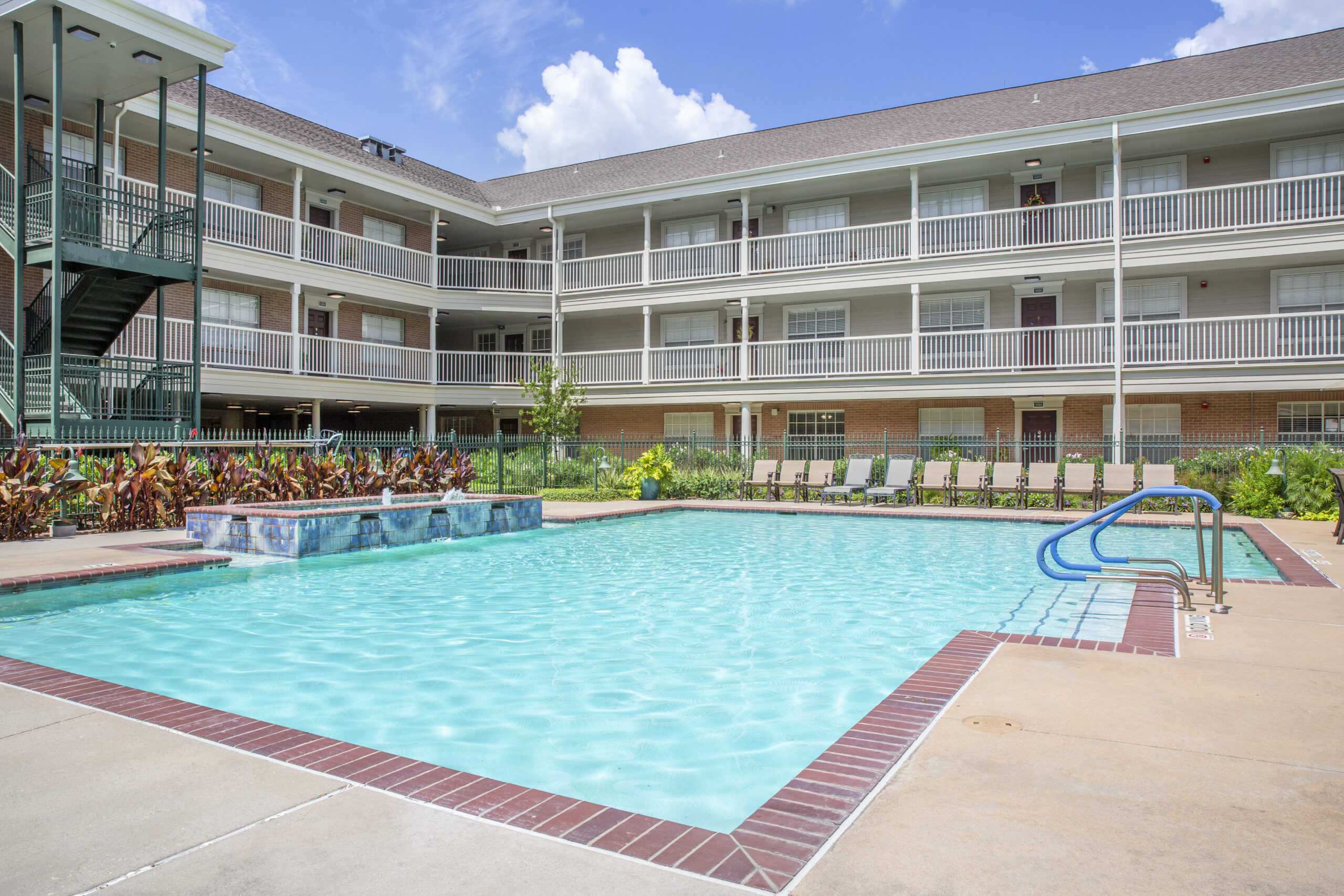 Swimming pool area with accessible entry and landscaping