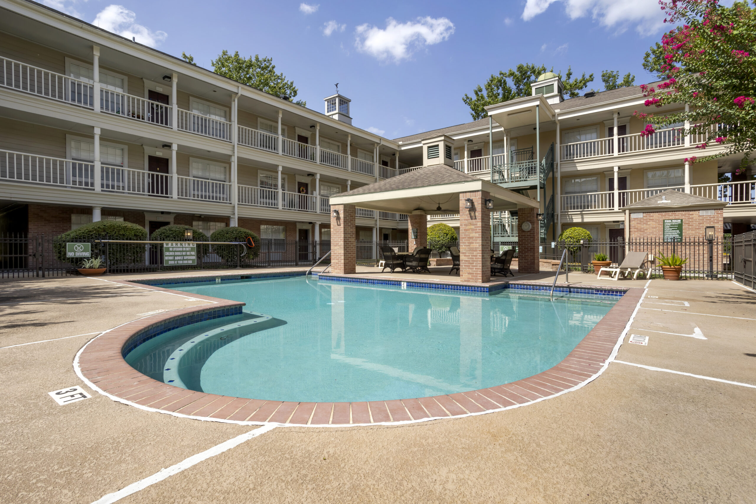 A serene pool area surrounded by residential buildings