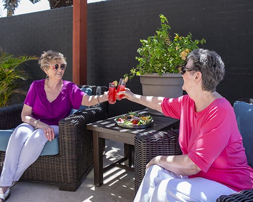 Residents enjoying refreshments on a patio