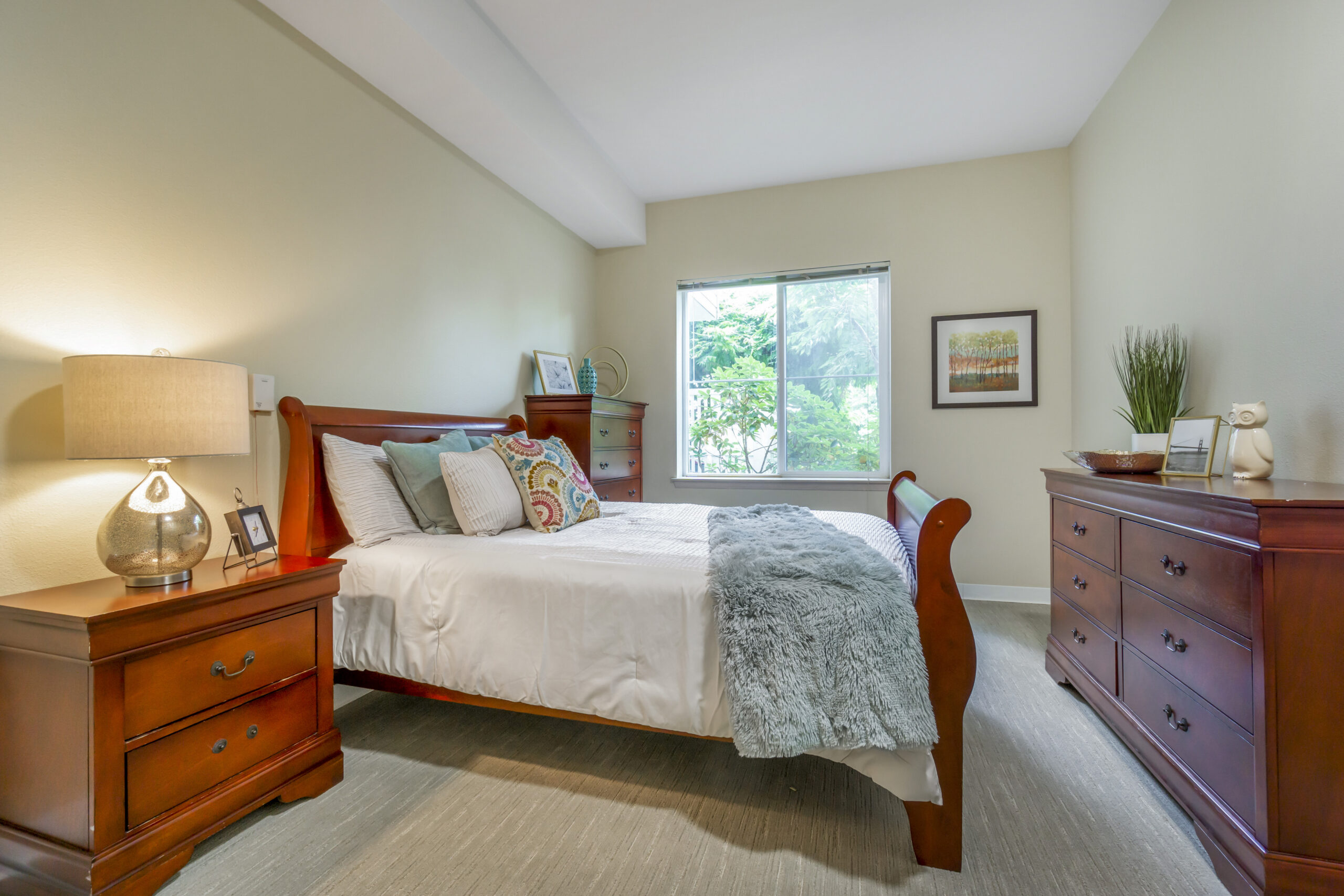 A cozy bedroom with wooden furniture and natural light