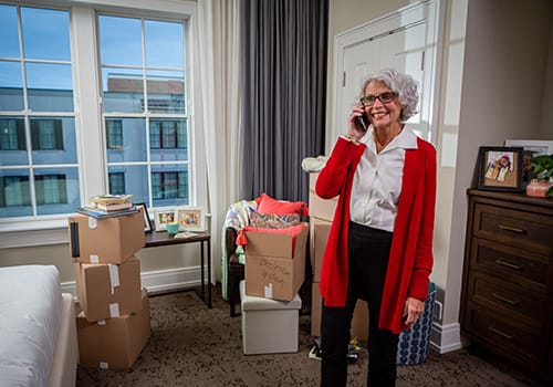 Resident on the phone in a newly furnished room