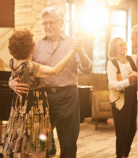 Residents dancing joyfully in a common area