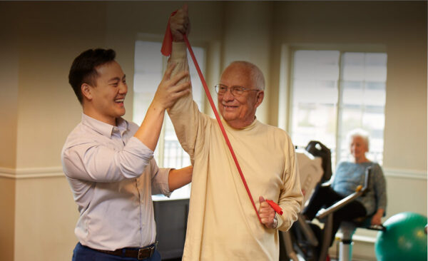 Resident engaging in physical therapy with staff member