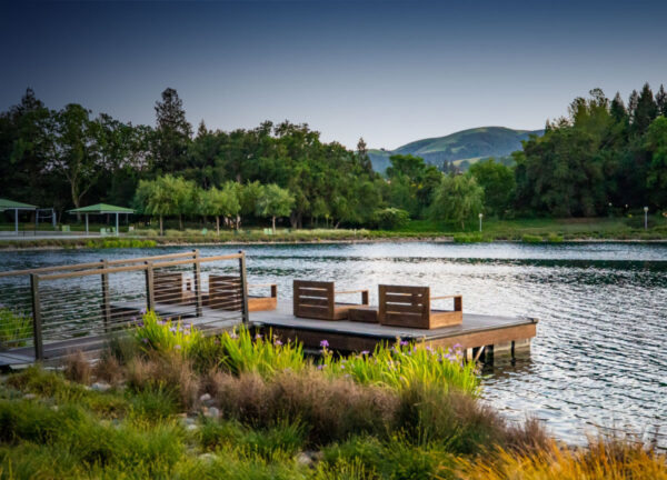 A serene outdoor space by a lake with seating