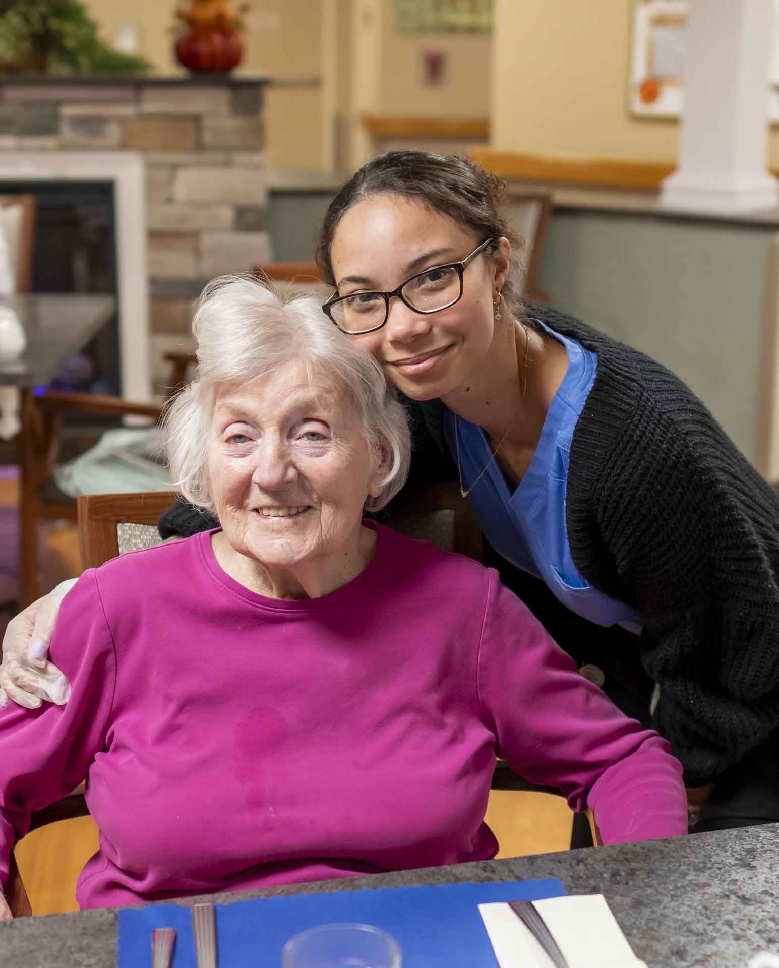 Staff member with a resident in a cozy dining area