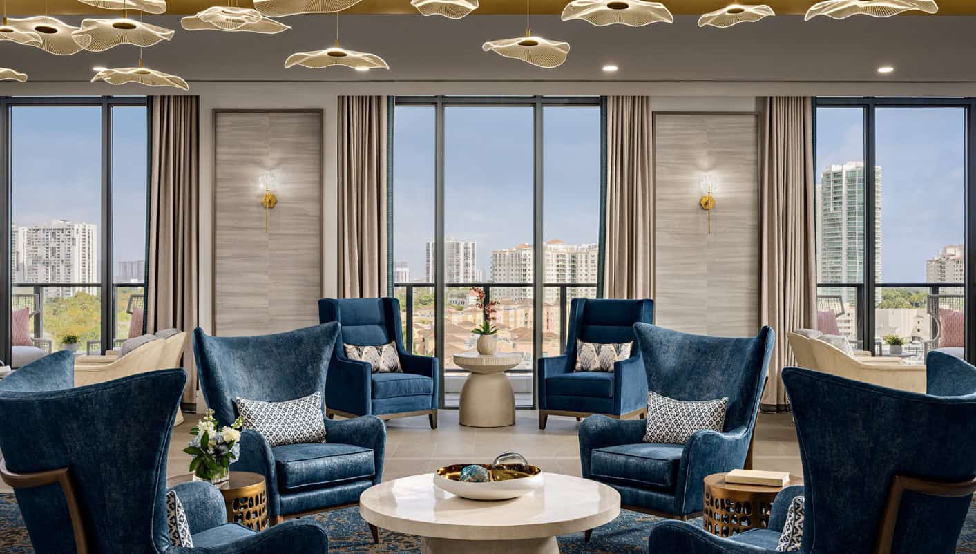 Bright common area with blue chairs and city view