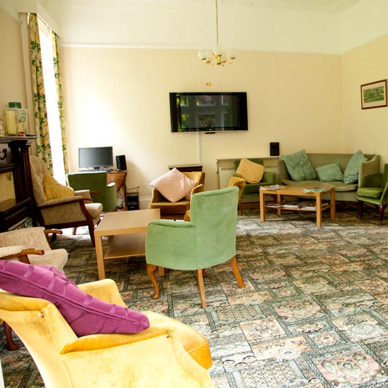 Bright common area with seating and a television