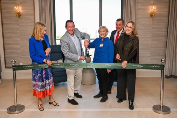 Staff and residents at a ribbon-cutting ceremony