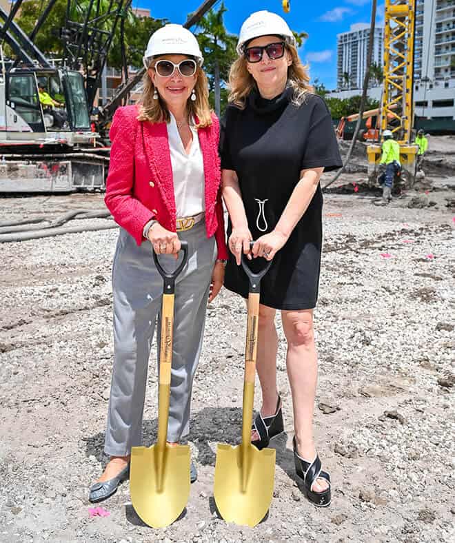 Two women participating in a groundbreaking ceremony