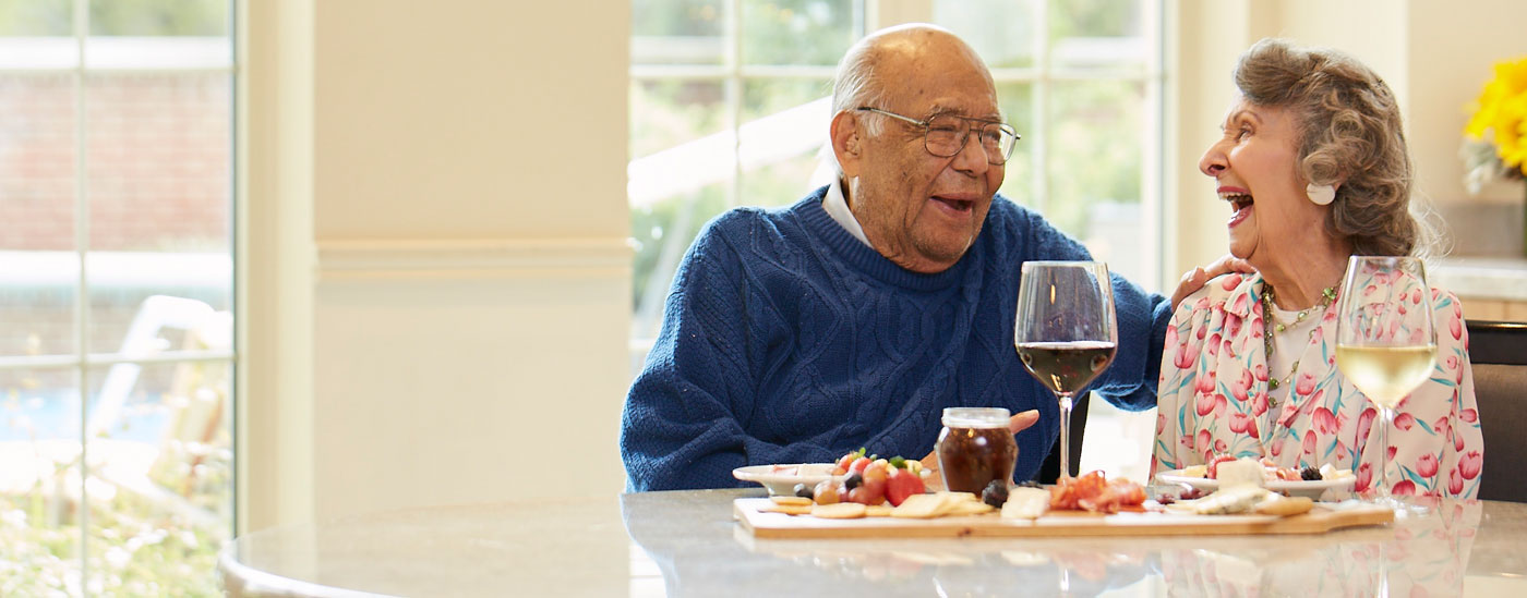 A couple enjoying a meal and laughing together