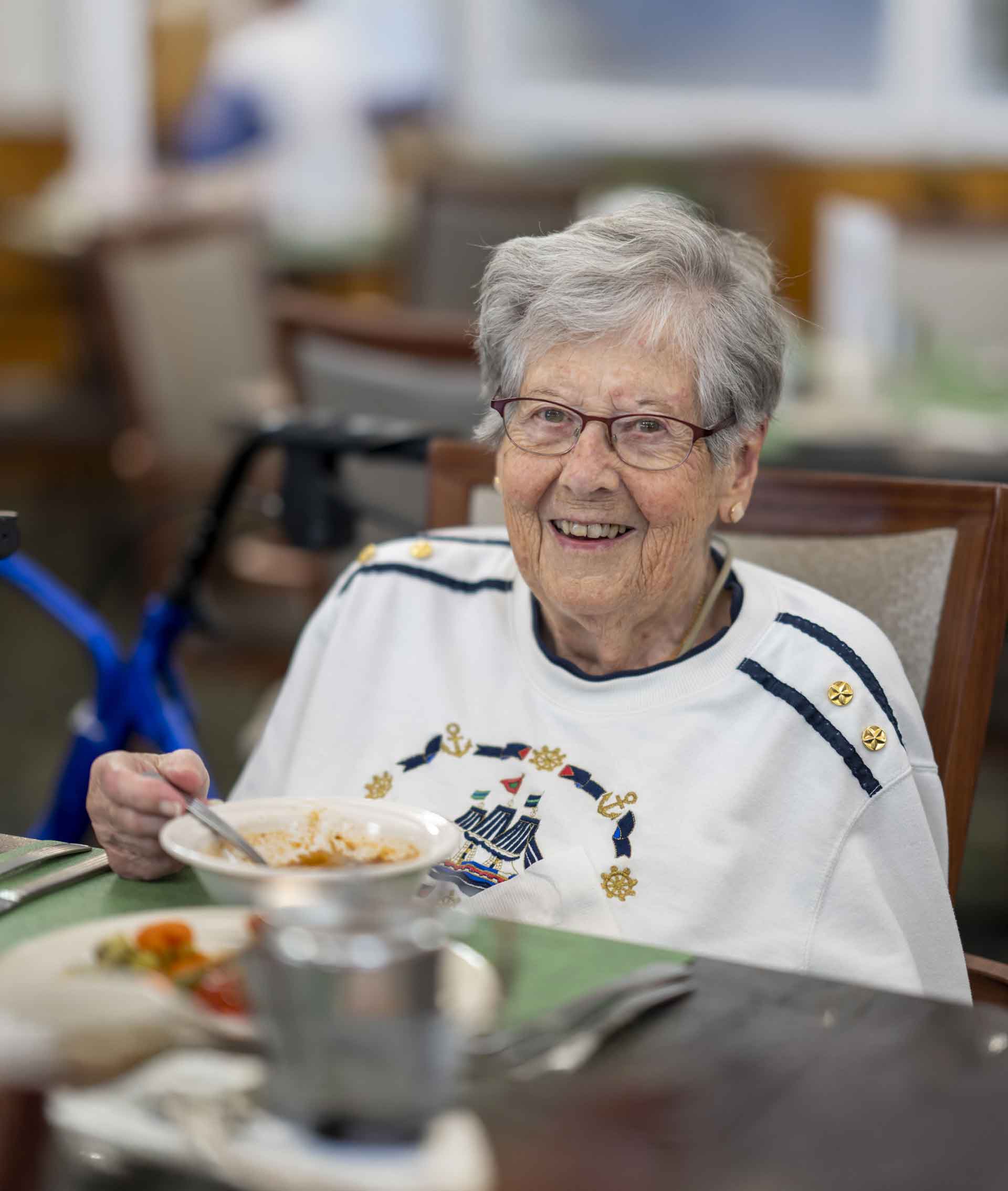 Resident enjoying a meal in the dining room