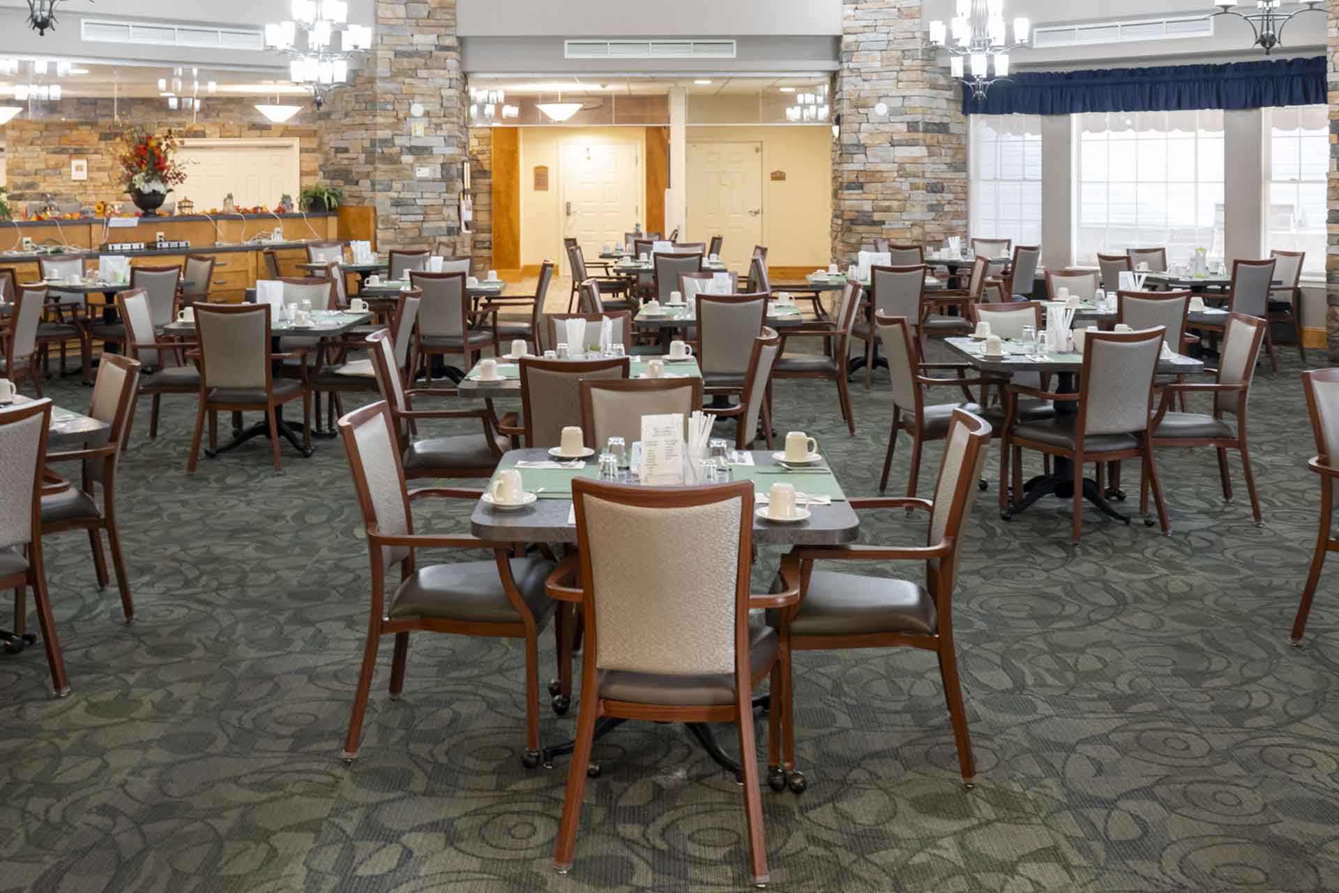 Dining room with tables set for residents