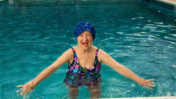 A joyful resident swimming in a pool