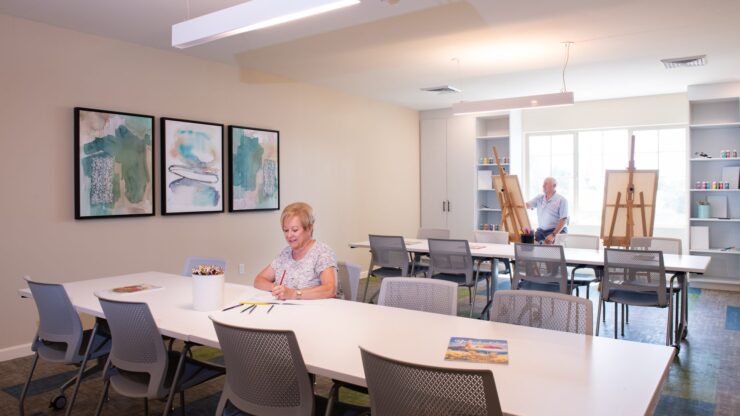 Residents engaged in an arts and crafts activity in a bright room