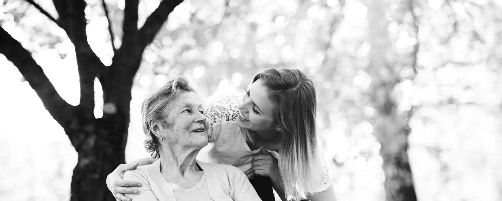 A woman and a senior resident enjoying time outdoors