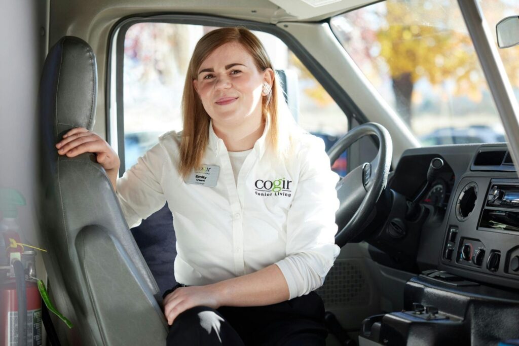 Female staff member in a facility transport vehicle