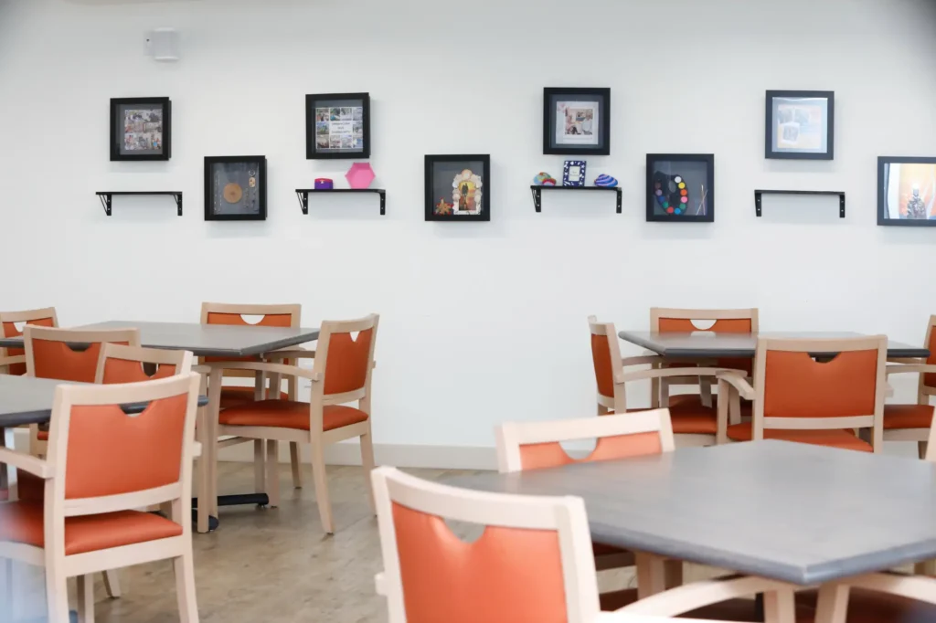 Interior view of a dining area with frames on the wall