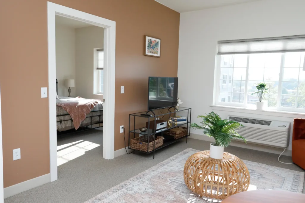 Spacious interior of a resident room with light decor