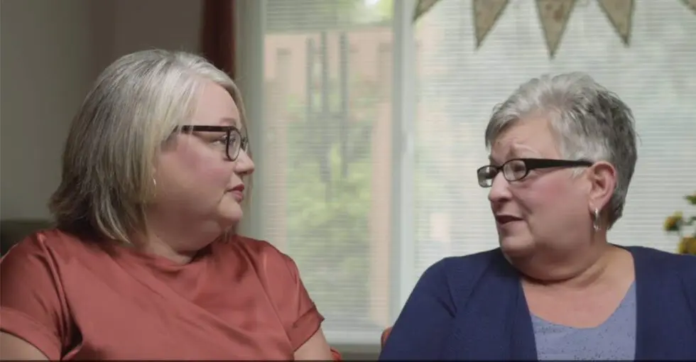 Two women chatting in a comfortable indoor setting
