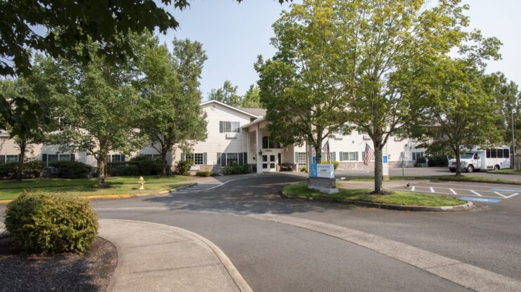 Exterior view of Cadence at Olney with trees and driveway