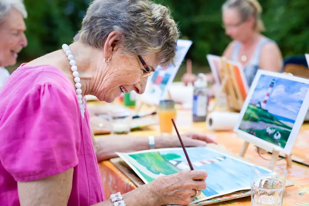 Residents enjoying an outdoor painting activity