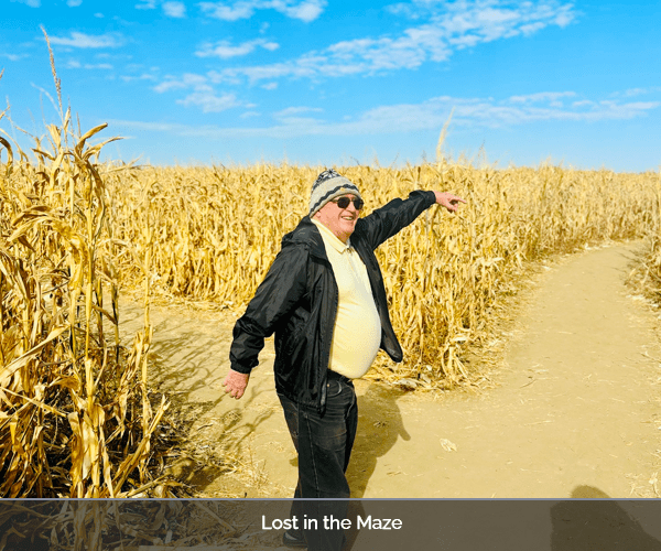 A resident exploring a corn maze outdoors
