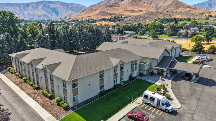 Aerial view of the assisted living facility with outdoor space and a shuttle van