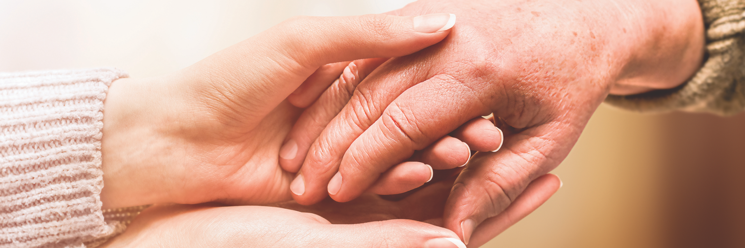 Two hands gently holding each other