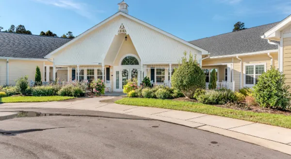 Exterior view of a senior living facility with gardens