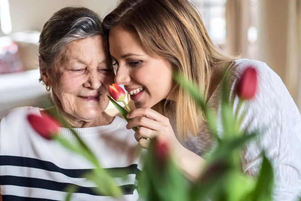 Senior resident enjoying time with a caregiver indoors