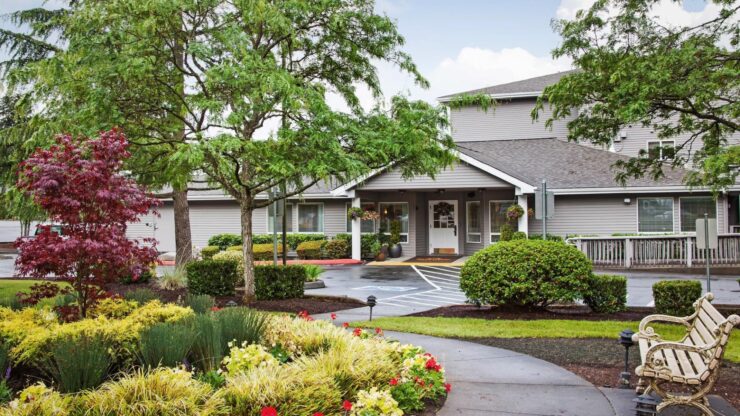 Entrance of a senior living facility with landscaped gardens