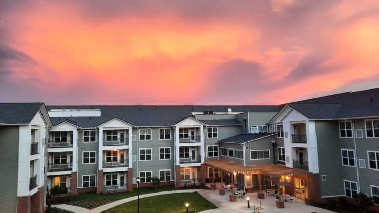 Exterior view of the facility with a colorful sunset