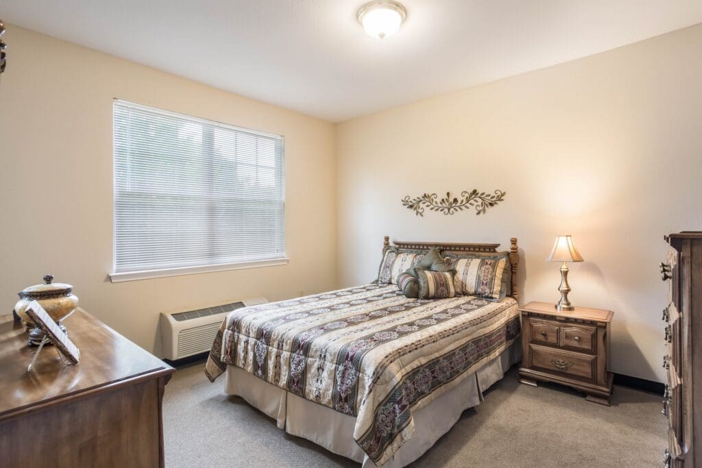 A cozy bedroom with a decorative bedspread