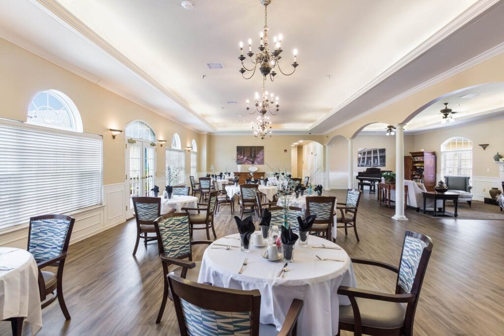 Bright dining room with elegant decor and tables set for dining