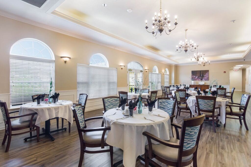 Elegant dining area with set tables and chandeliers
